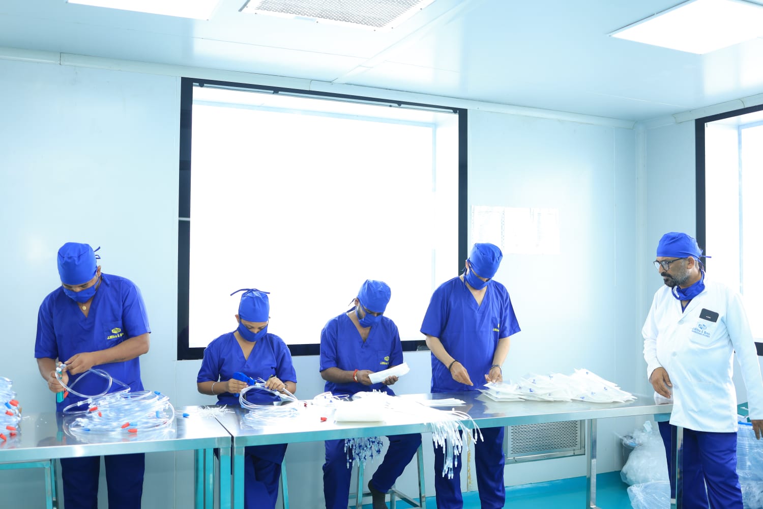 Technicians assembling medical disposables at the Sonepat facility
